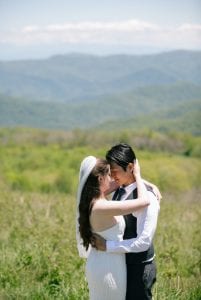 A Bride and Groom embracing during their elopement portraits at Max Patch